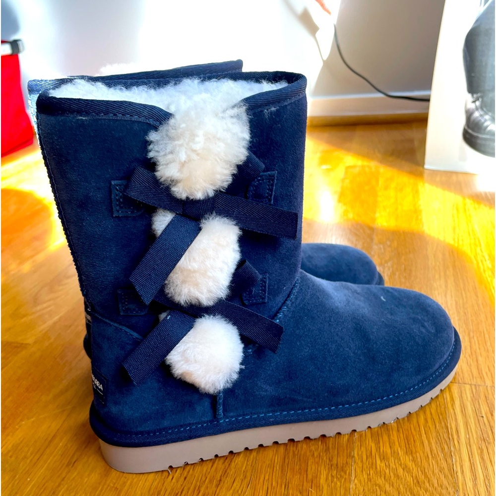 Koolaburra navy boots w/bows. Never been worn. No tags. Size 7